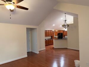 Interior home painting 'after' shot in Columbia, showing professional finish on high vaulted ceilings, clean lines along white baseboards, and expertly painted walls in a modern neutral palette